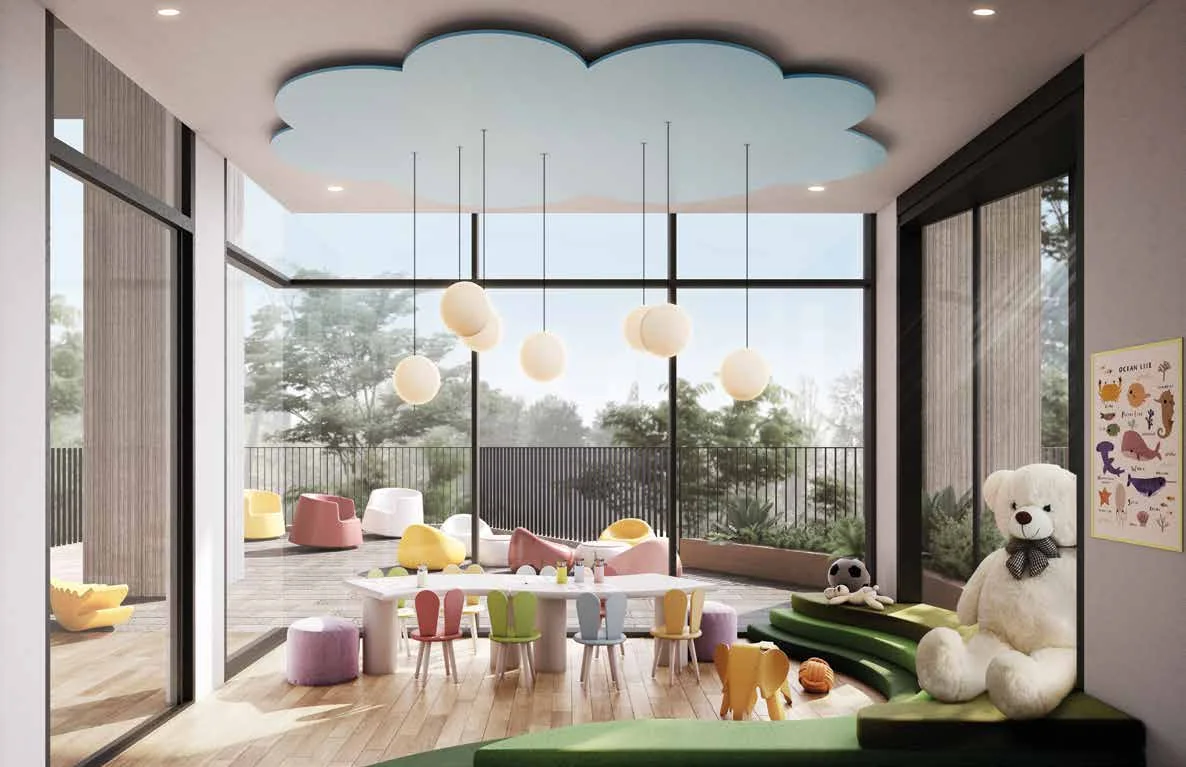 A bright kids club room with a cloud-shaped ceiling, low tables and a garden view.